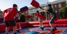 four people joust on an inflatable court