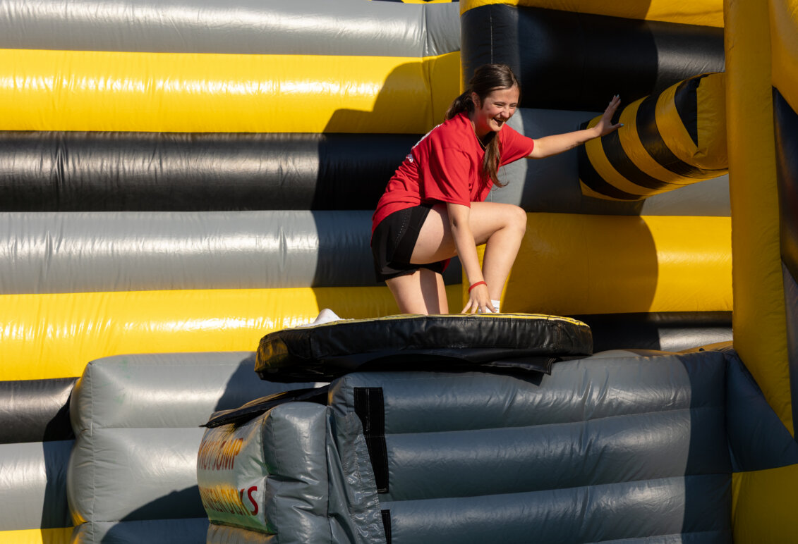 a girl climbs on an inflatable