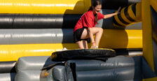 a girl climbs on an inflatable