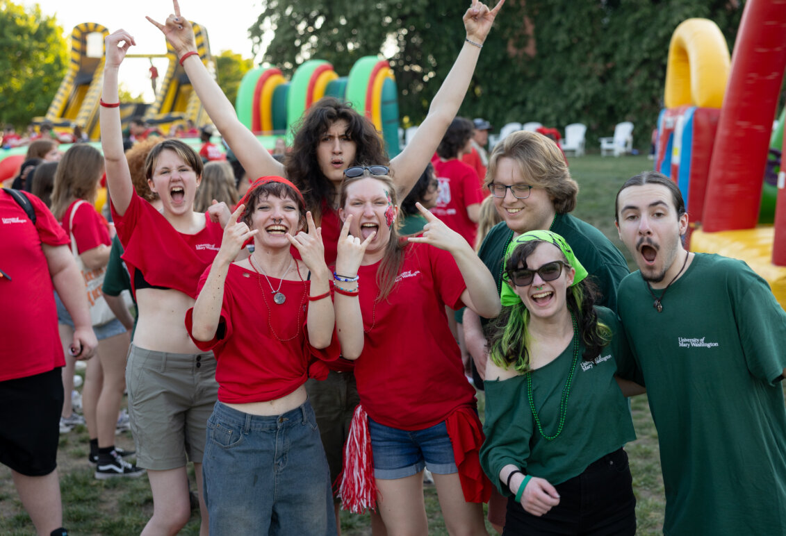 a group of students dressed in red and green cheer