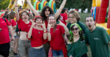 a group of students dressed in red and green cheer