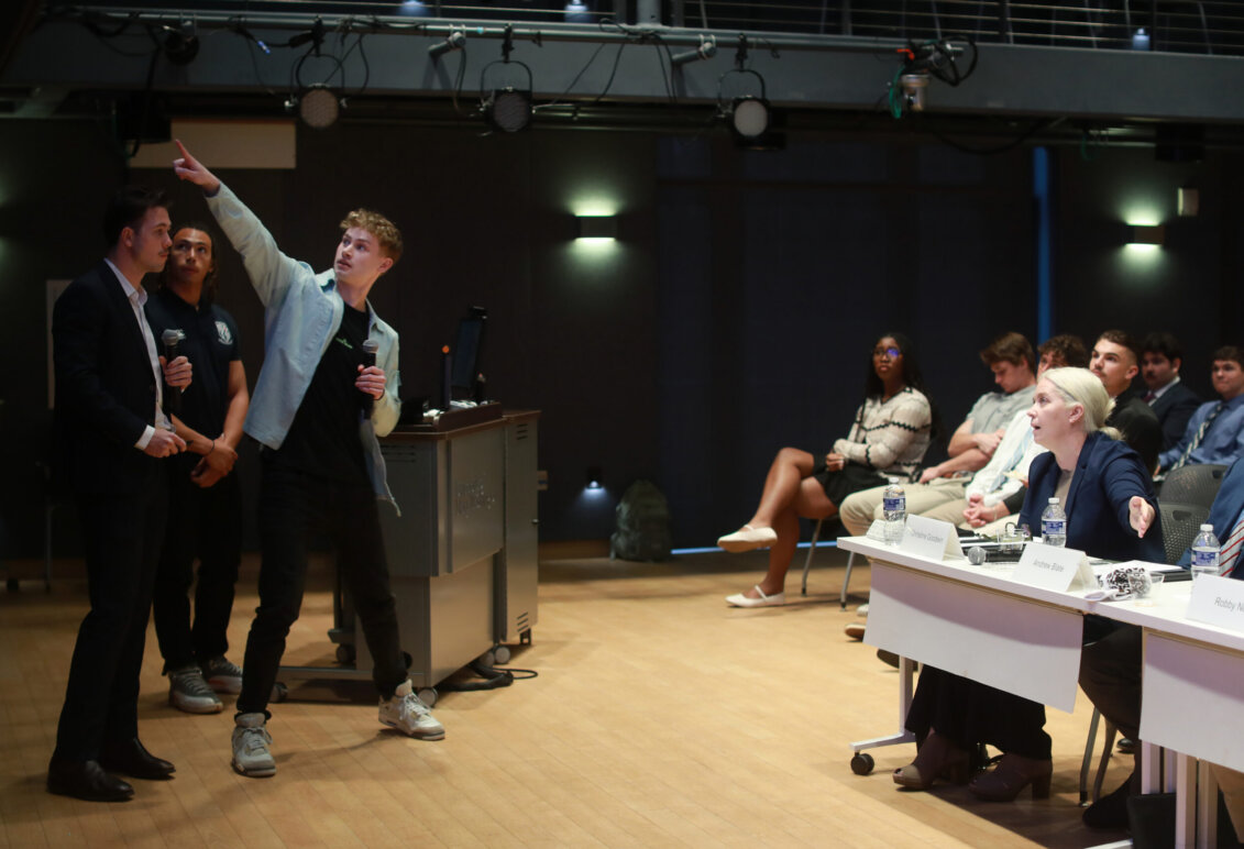 Students present to an audience in the HCC on campus