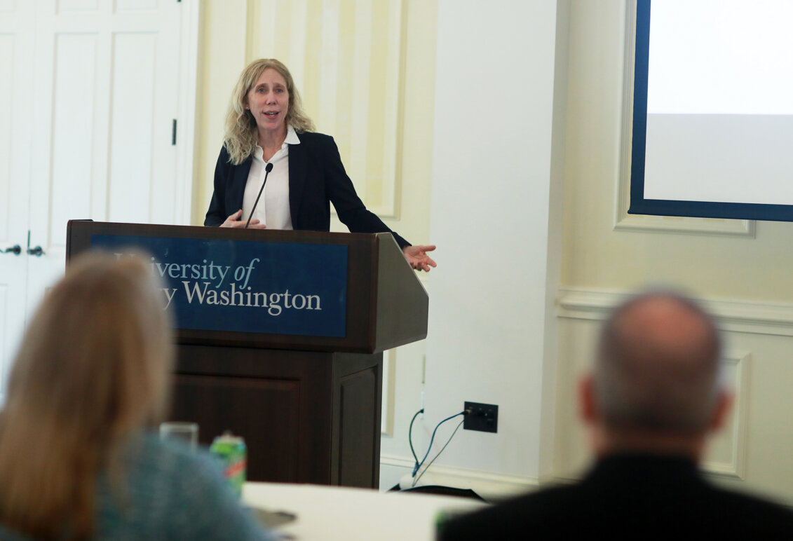 Betsy Lewis at a podium speaking
