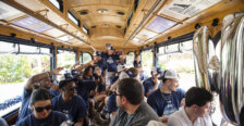 A basketball team is shown riding inside a trolley