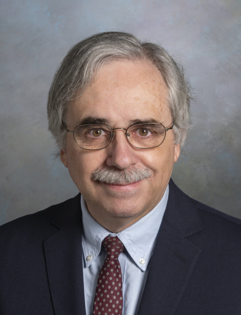 A portrait of a man wearing a suit and tie