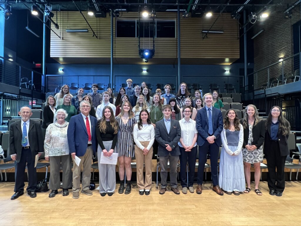 A group of about 50 people pose for a photo