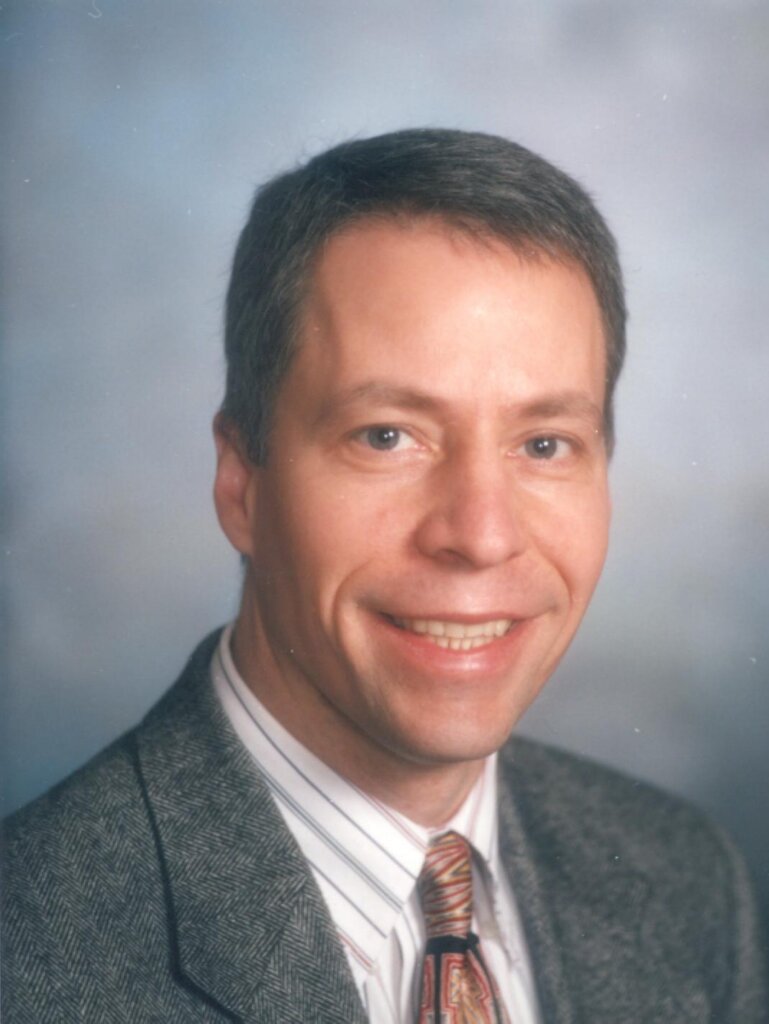 A photo of a man wearing a suit and tie