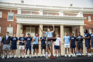 Photo of basketball players on the stage in front of Virginia Hall