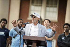 Photo of President Paino speaking at the podium on the stage