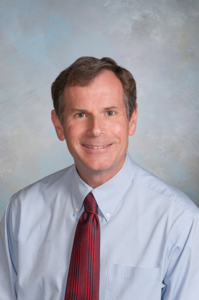 A photo of a man wearing an oxford and a tie