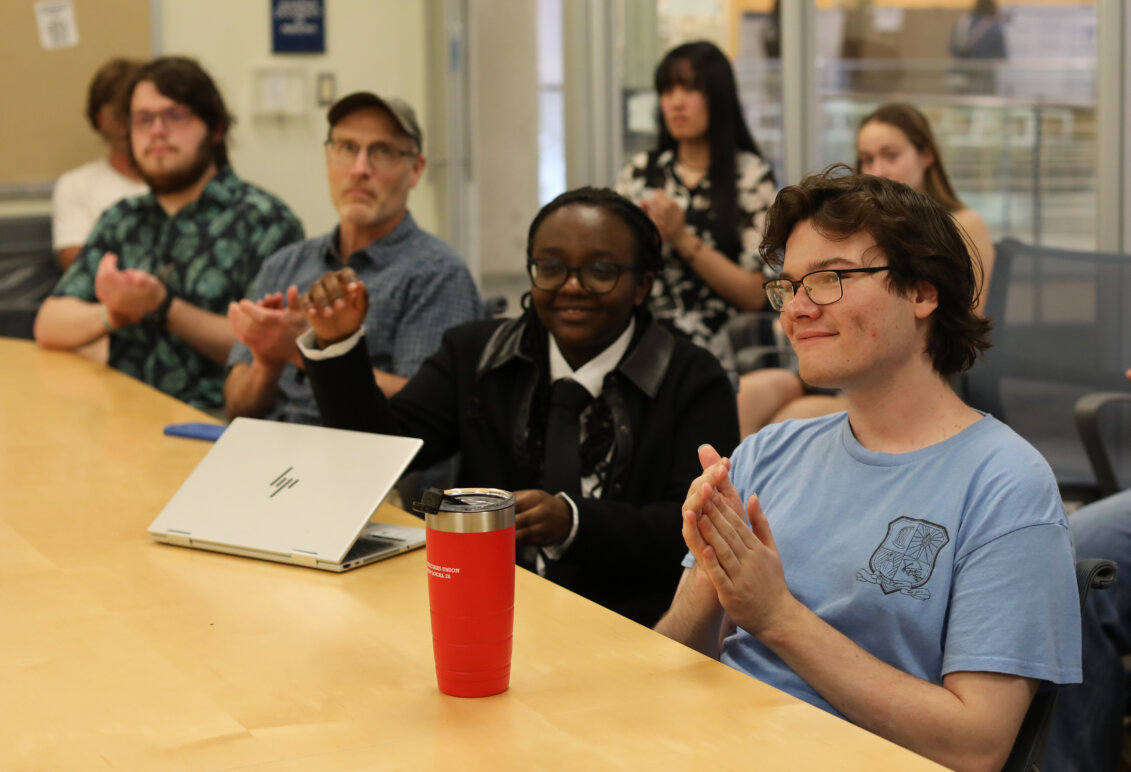 Students in a classroom listen to a presentation