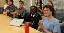 Students in a classroom listen to a presentation