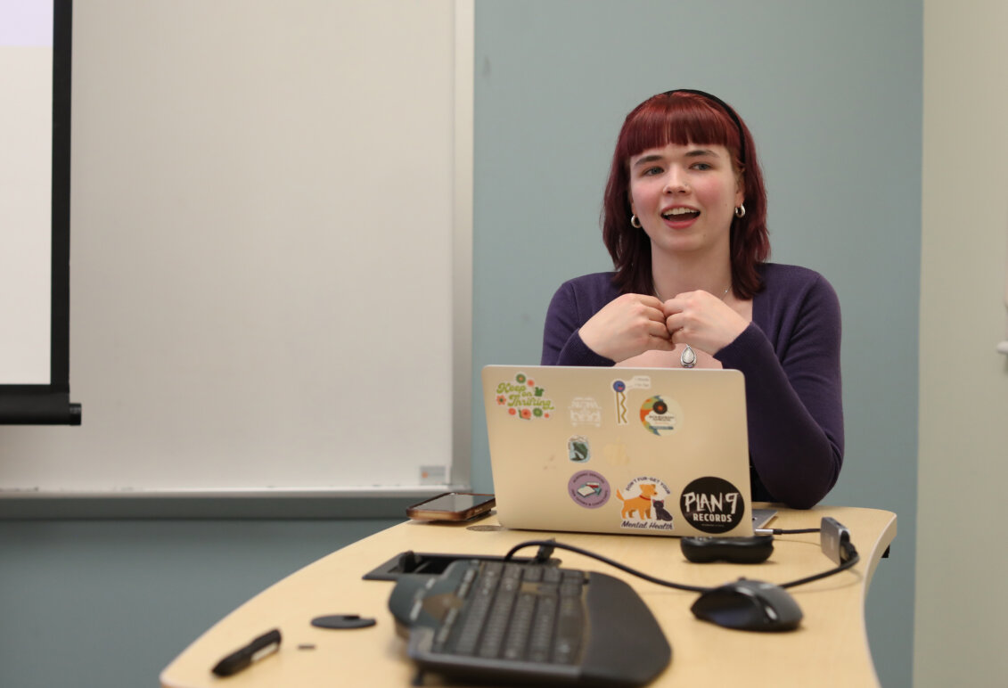 A females student at the podium gives an oral presentation