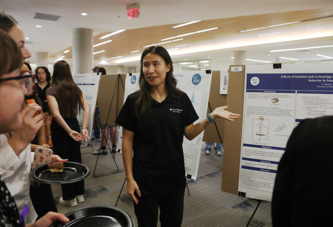 A student presents a poster