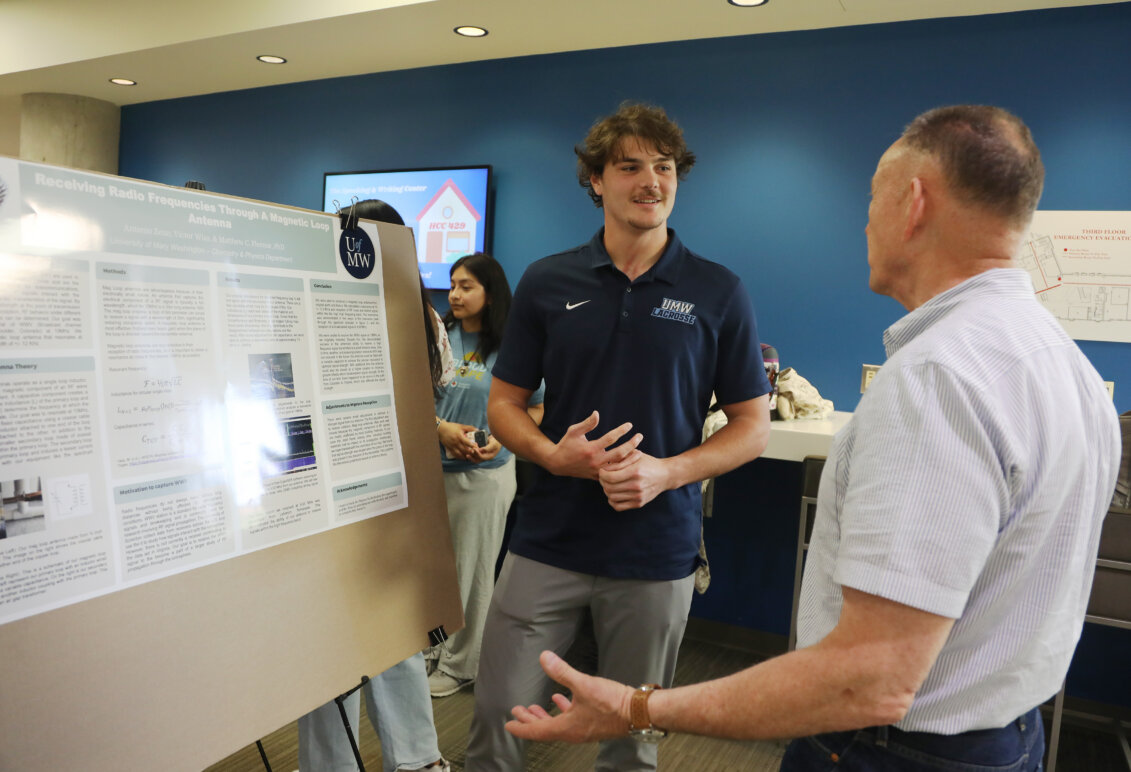 A male student presents his poster