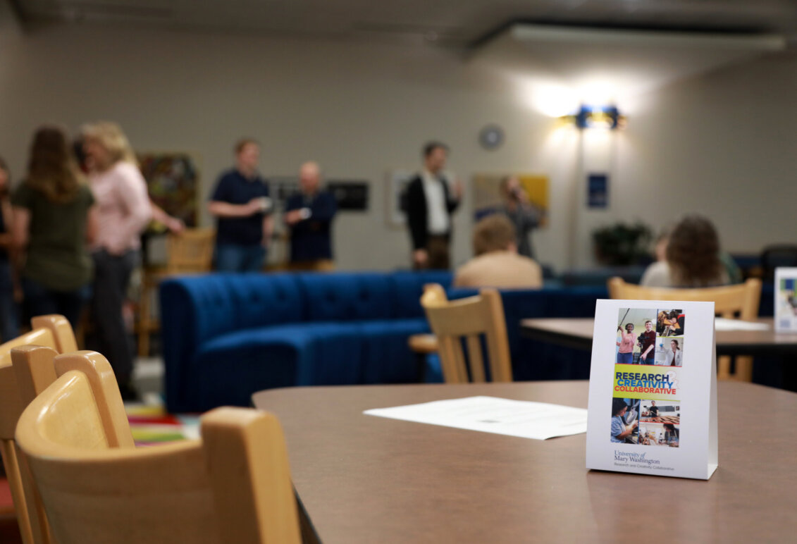 A table, chairs and a couch in the Research and Creativity Collaborative section of Simpson Library