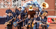 The UMW pep band with their instruments and UMW mascot Sammy D. Eagle.