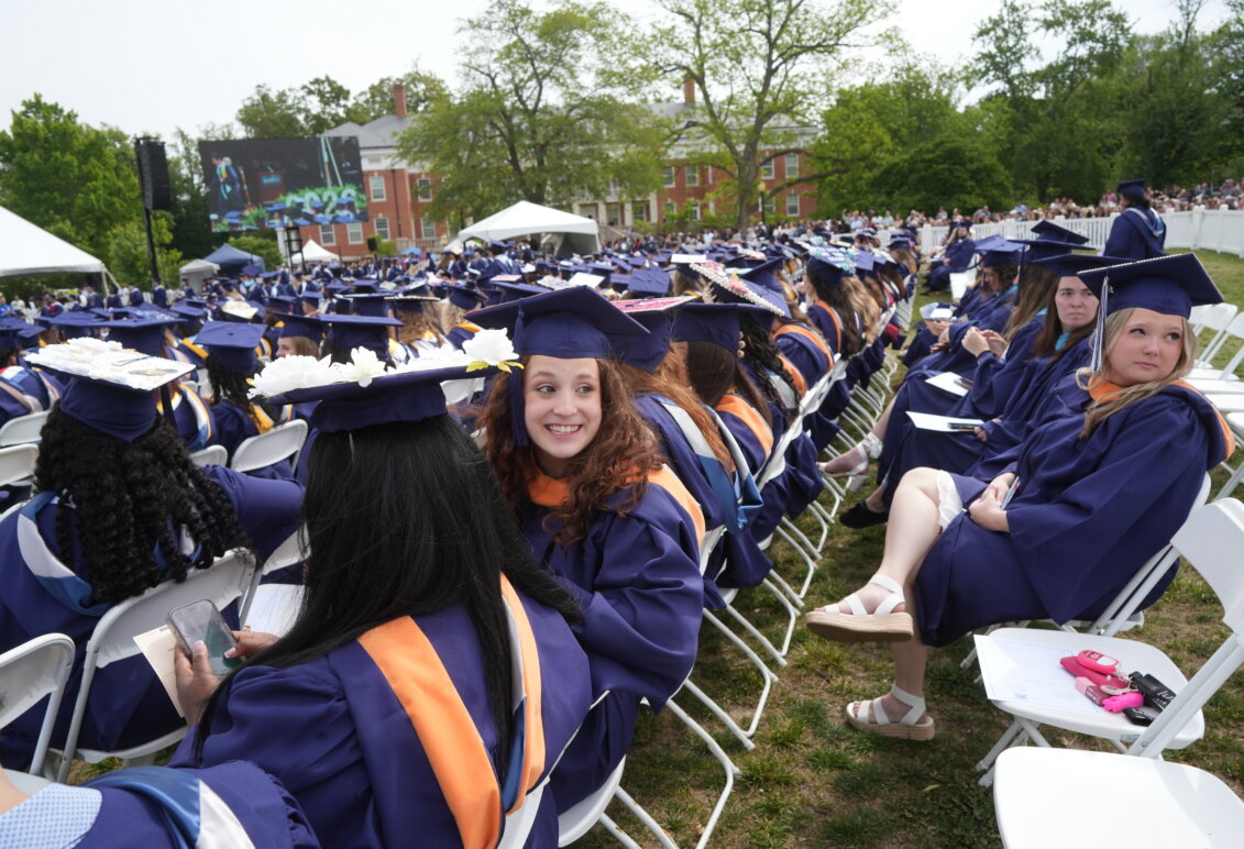 A lawn filled with soon-to-be graduates