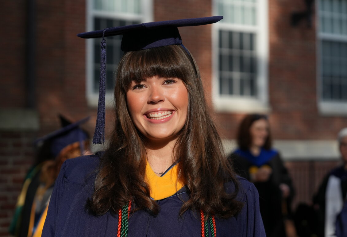 A graduate smiles for the camera
