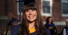 A graduate smiles for the camera