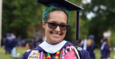 A graduate wearing colorful stoles