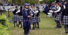 People dressed in kilts and playing bagpipes at a college graduation