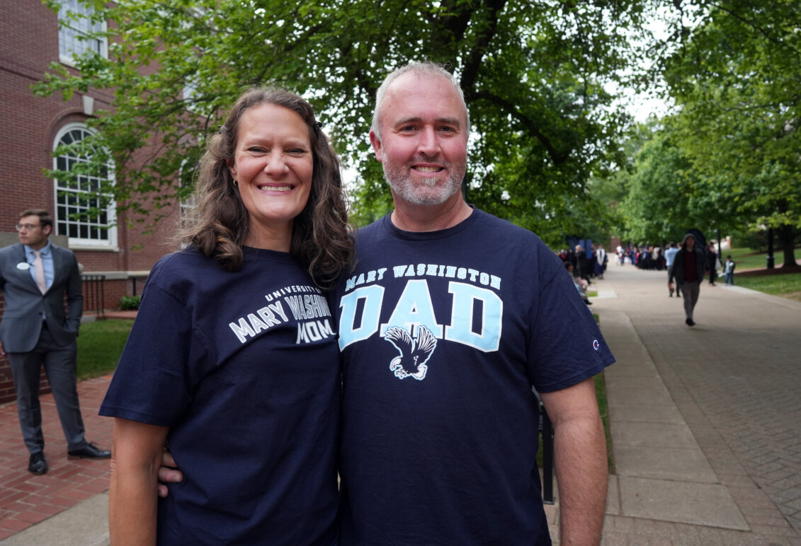 A mom and dad wearing Mary Washingon T-shirts