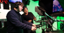 Clinton and Raven Jackson behind the camera with headsets on