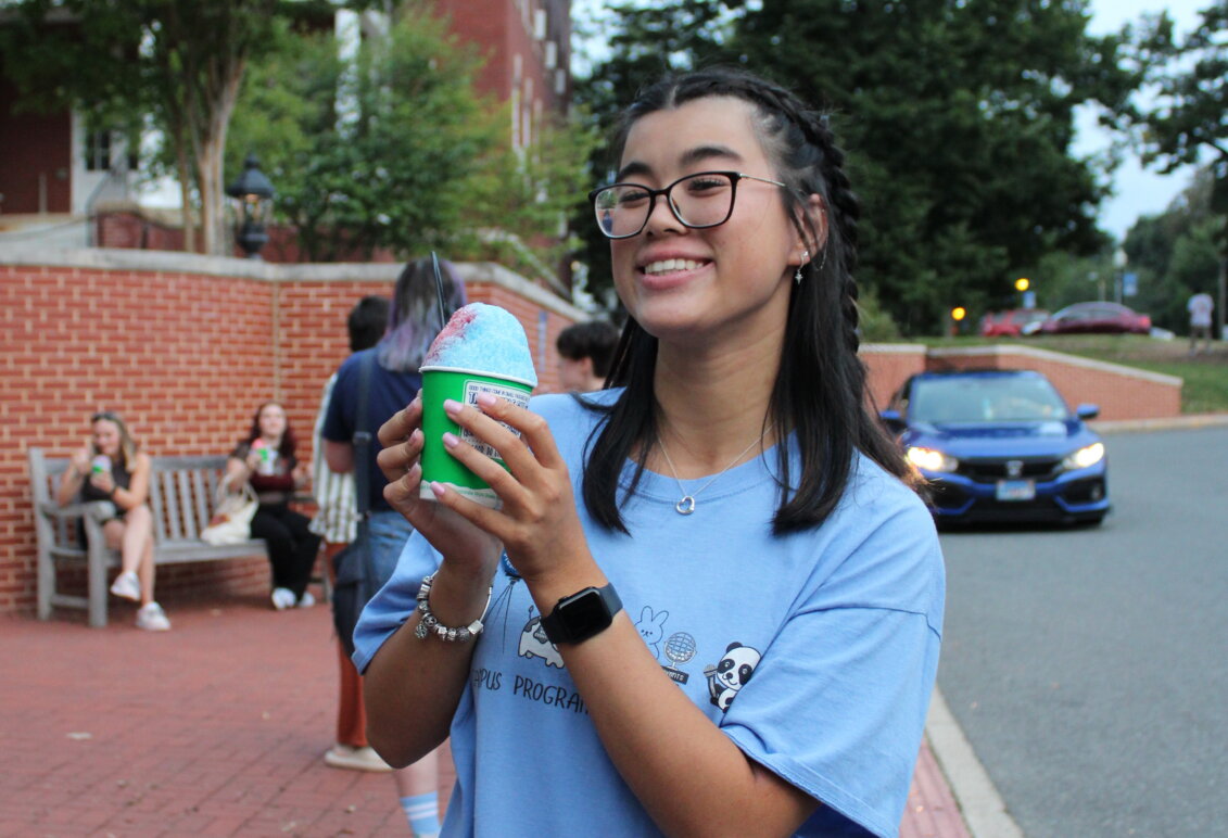 Ashley Lam holds a snow cone at a student event outdoors on campus
