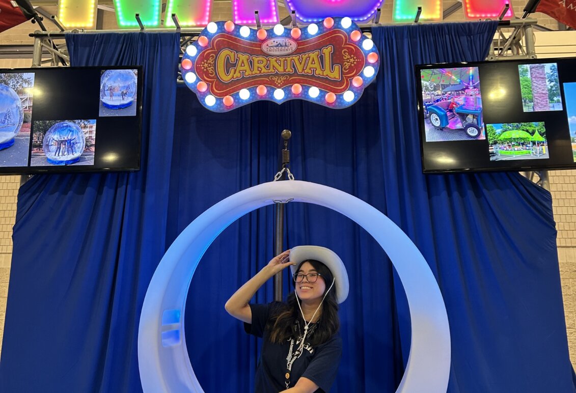 Ashley Lam sits in a swing at the National Association for Campus Activities conference