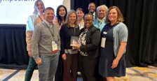 Bywaters-Baldwin poses with a group of people from Rappahannock Goodwill at the Virginia Workforce Symposium