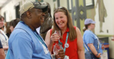 Two alumni laugh and enjoy wine tasting at the Virginia wine, beer, and cider tasting during Reunion Weekend.