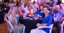 A group of alumni raise their glasses in a toast while seated a table at the all-class party during Reunion Weekend.