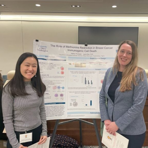 Thompson and Sipe standing with their research poster.