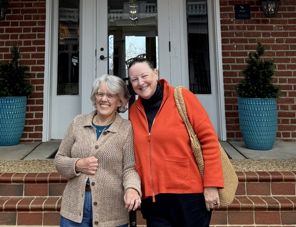 Two 1976 alumnae standing on the Kalnen Inn steps at UMW.