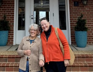 Two 1976 alumnae standing on the Kalnen Inn steps at UMW.