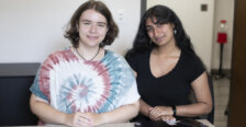 Two students pose together while smiling at the camera.