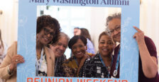 Five 1976 alumnae pose for a photo with a photo frame that reads 'Mary Washington Alumni Reunion Weekend.'