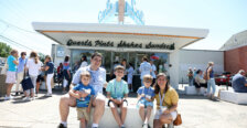 Two alumni parents and their three children eating ice cream in front of Carl's Frozen Custard.