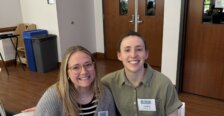 Brianna Burckhalter seated with award winner, Carolina Brusch '23 at COB Alumni Awards event