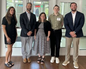 Five 2026 College of Business alumni award winners standing in Woodard Hall