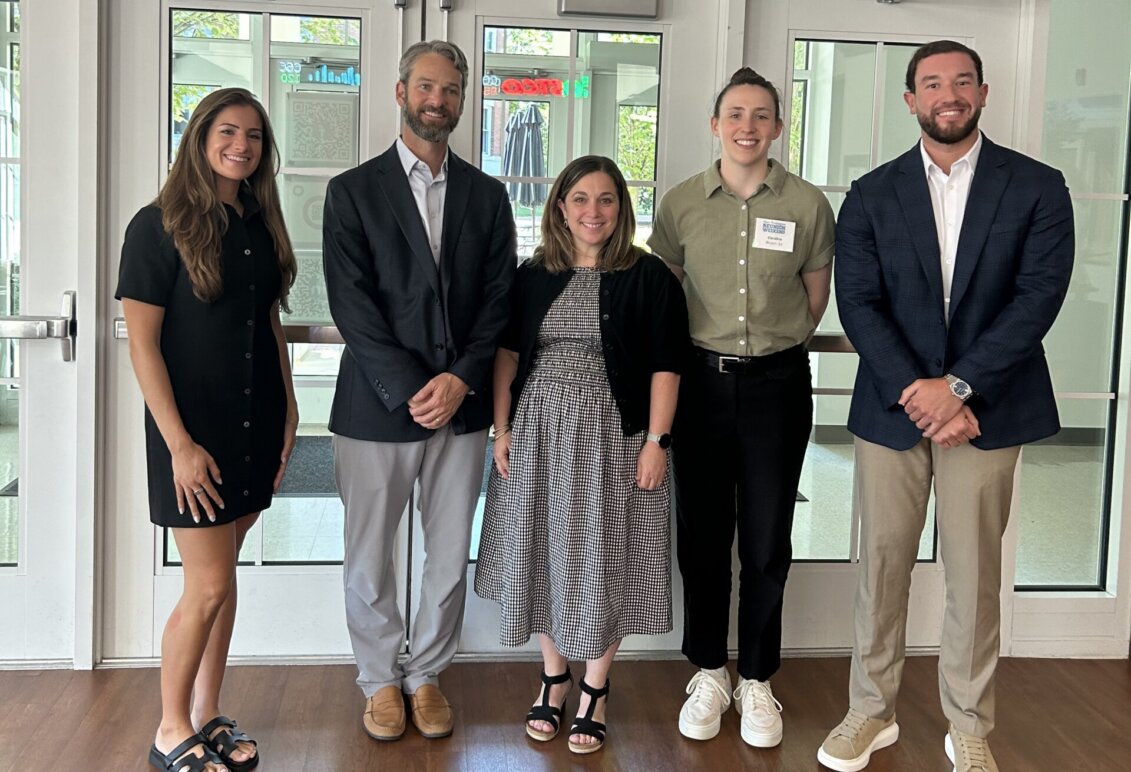 Five 2026 College of Business alumni award winners standing in Woodard Hall