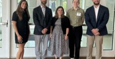 Five 2026 College of Business alumni award winners standing in Woodard Hall