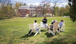 Enhanced Summer Visit Photo with students sitting on chairs in Ball Circle