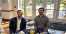 Luis Gavignano and his brother seated at a table in Woodard Hall at the awards event