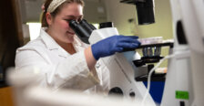 Senior Brooke Martin looks through a microscope during 2026 Summer Science Institute