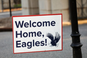 a sign that says "Welcome Home, Eagles!" on on campus on move-in day