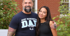 A man wearing a "Mary Washington Dad" T-shirt hugs his daughter