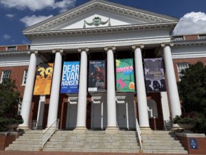 UMW's duPont building on a sunny day with banners hanging between columns advertising the productions for the 2026-27 academic year