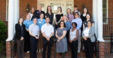 A group of UMW students, faculty and staff standing on the Kalnen Inn steps.